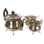 A George V silver three piece tea set by WA, the squat form vessels on four pad feet supports,