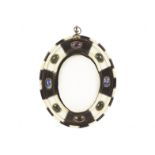 A Victorian Rennaissance style picture frame, the oval form with banded edge and panels of