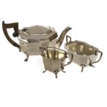 An Edward VIII silver three piece tea set by EV, octagonal form on four paw supports, comprising tea