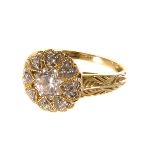 A 14ct gold and cubic zirconia dress ring, the cluster style circular tablet set with a large cut