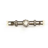 A Victorian diamond and pearl bar brooch, having a central cluster of old cuts centred by a pearl,