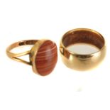 A thick 9ct gold plain wedding band, approx 5.3g, together with a 9ct gold and hardstone ring,