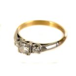 A pretty Art Deco period three stone diamond engagement ring, the graduating brilliant cuts in