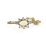 A vintage opal and cucic zirconia star brooch, on gold bar, approx 5g, with safety chain