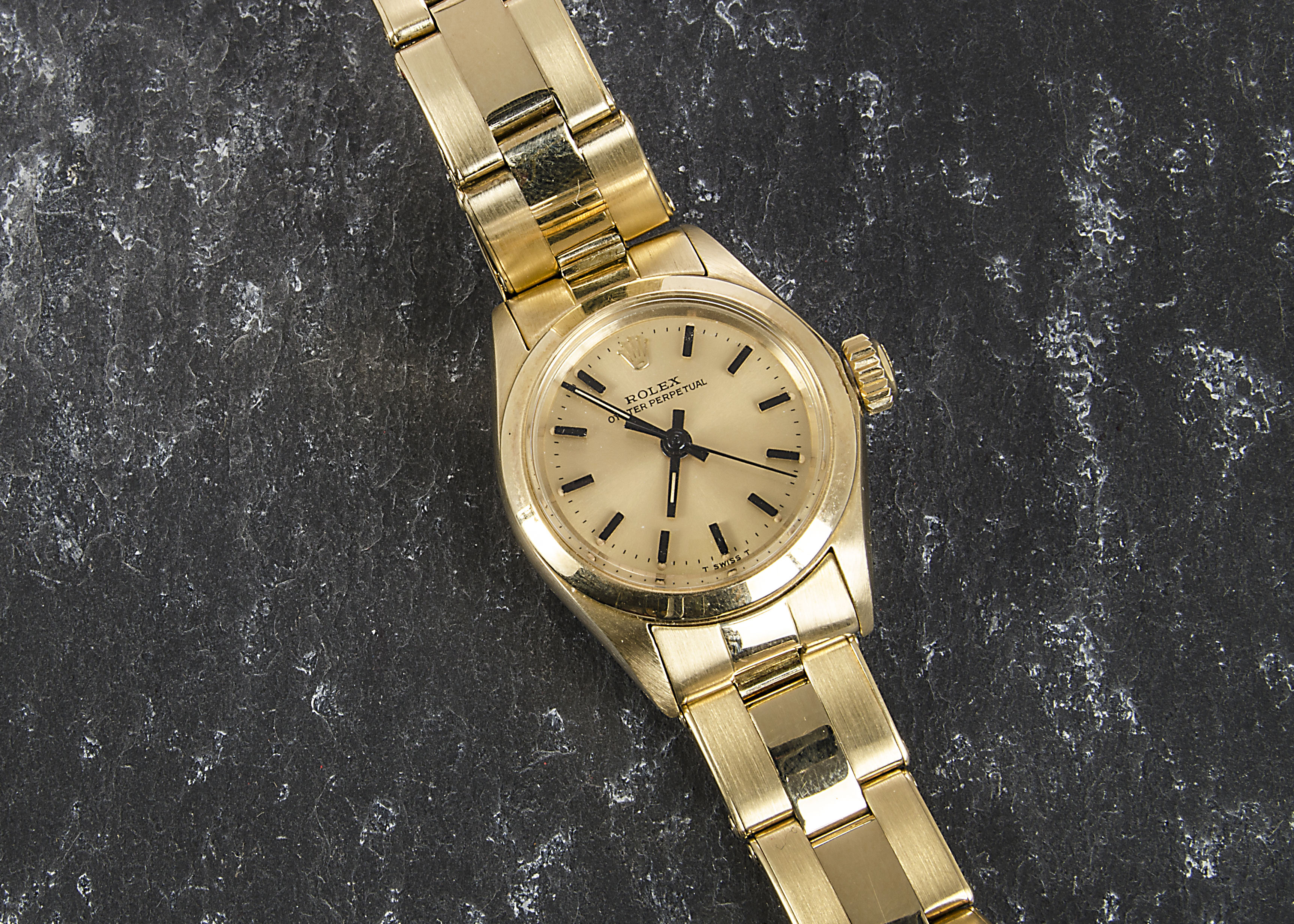 A 14ct gold Rolex Oyster Perpetual lady’s wristwatch, having black baton numerals to gold dial, in