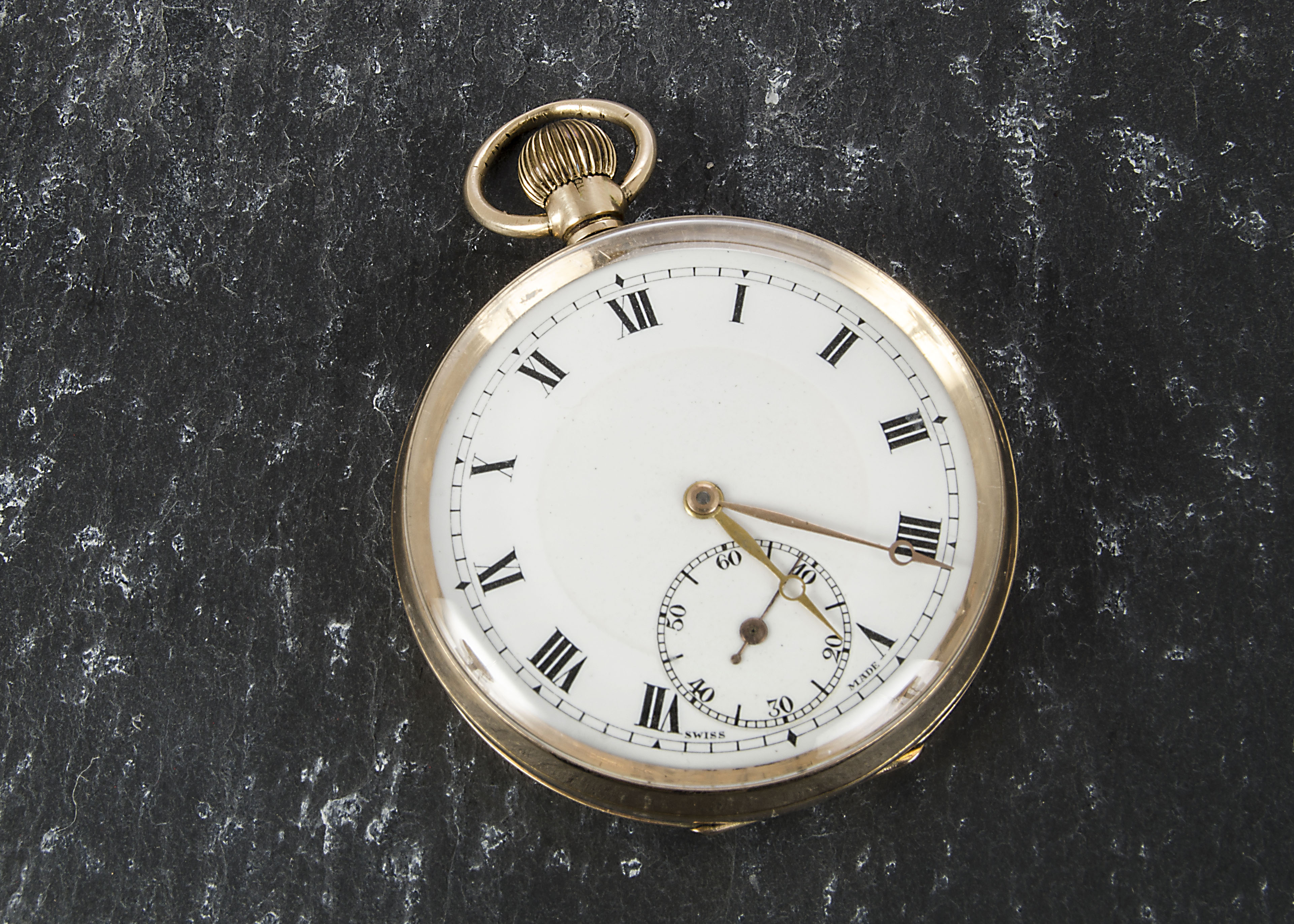 A Swiss 9ct gold cased open faced pocket watch, import marked London 1919, white enamel dial with