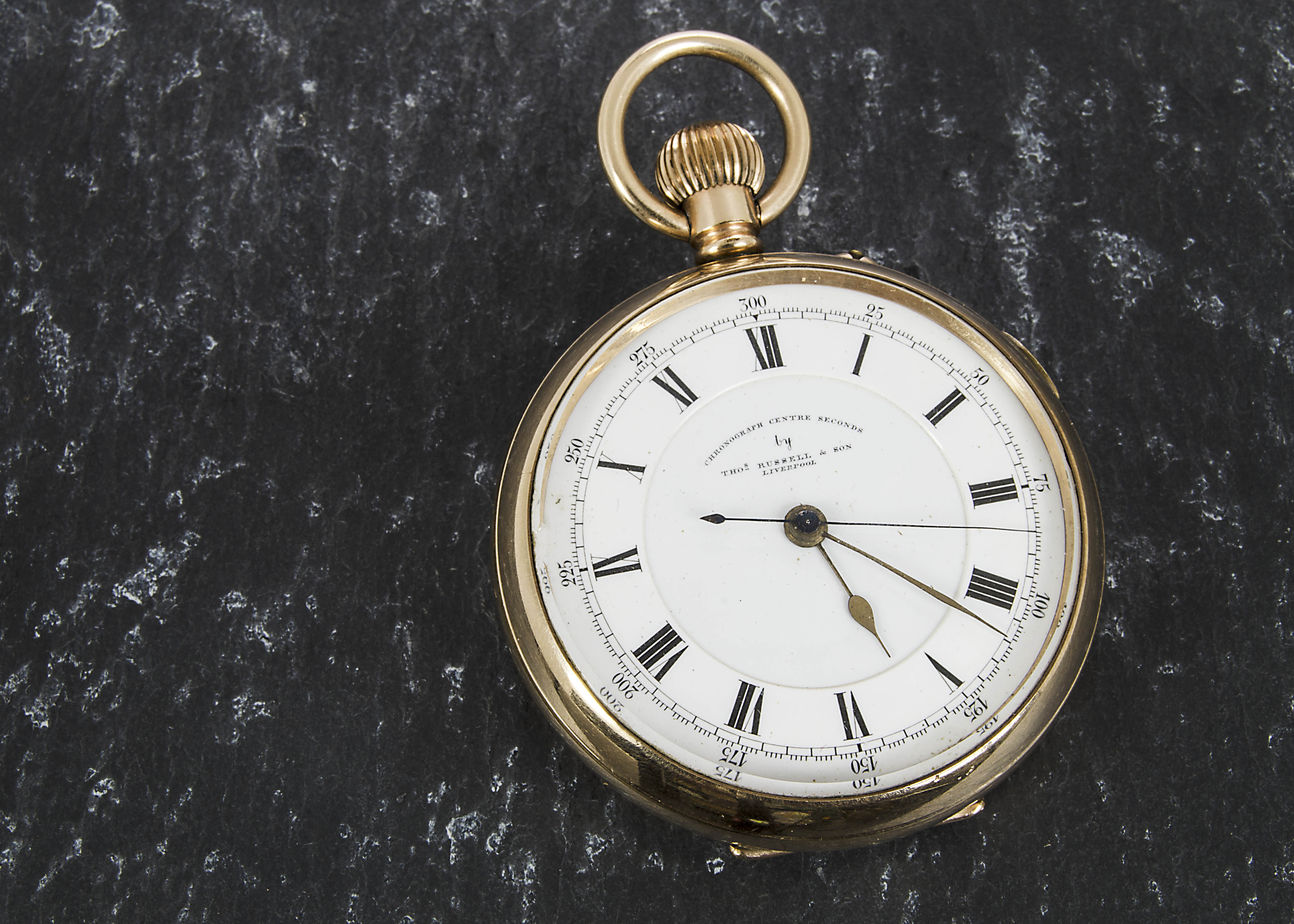 An early 20th century gold plated open faced chronograph pocket watch by Thomas Russell & Son,