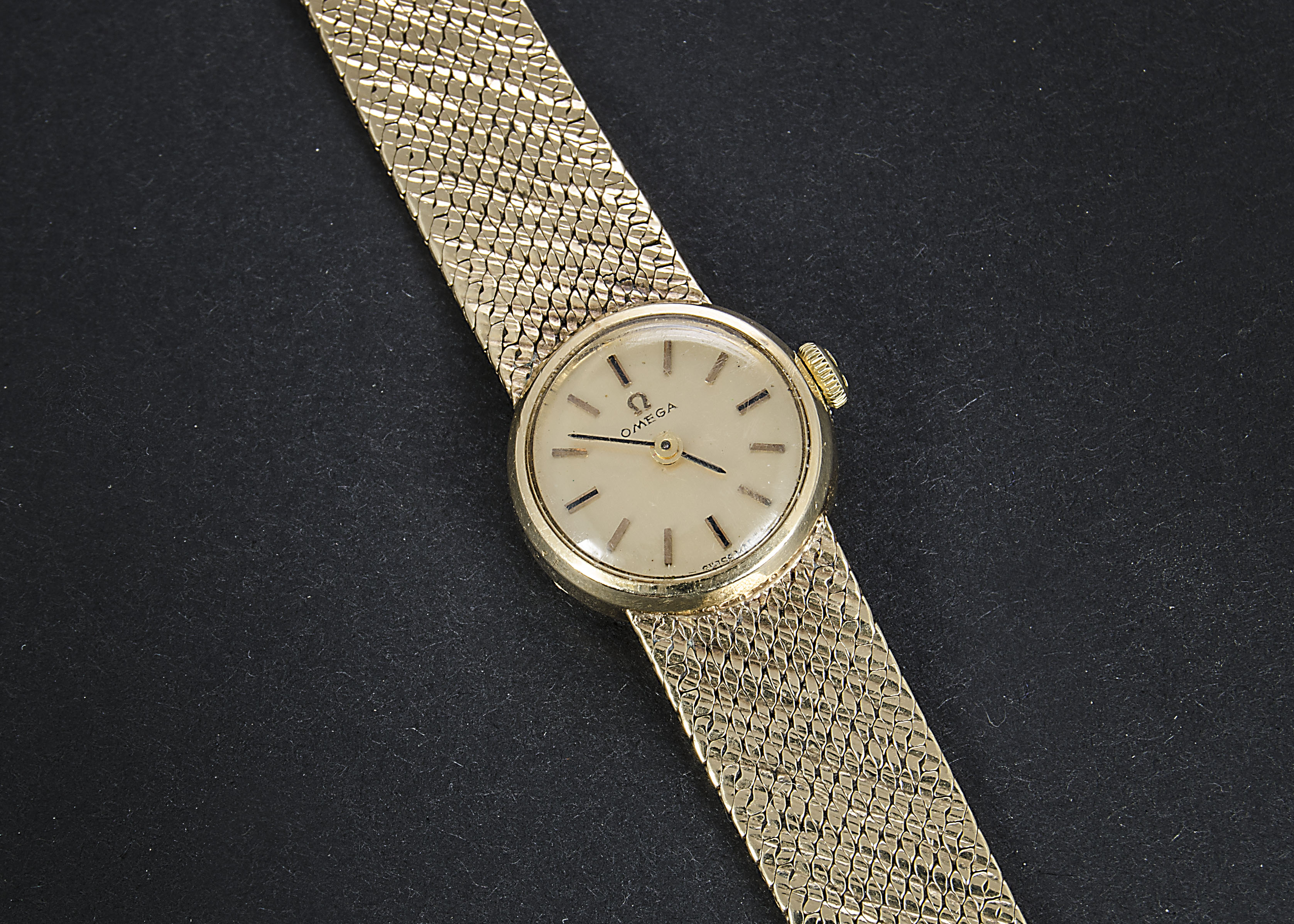 A 1970s 9ct gold Omega lady’s wristwatch, circular case on mesh 9ct gold bracelet, together with