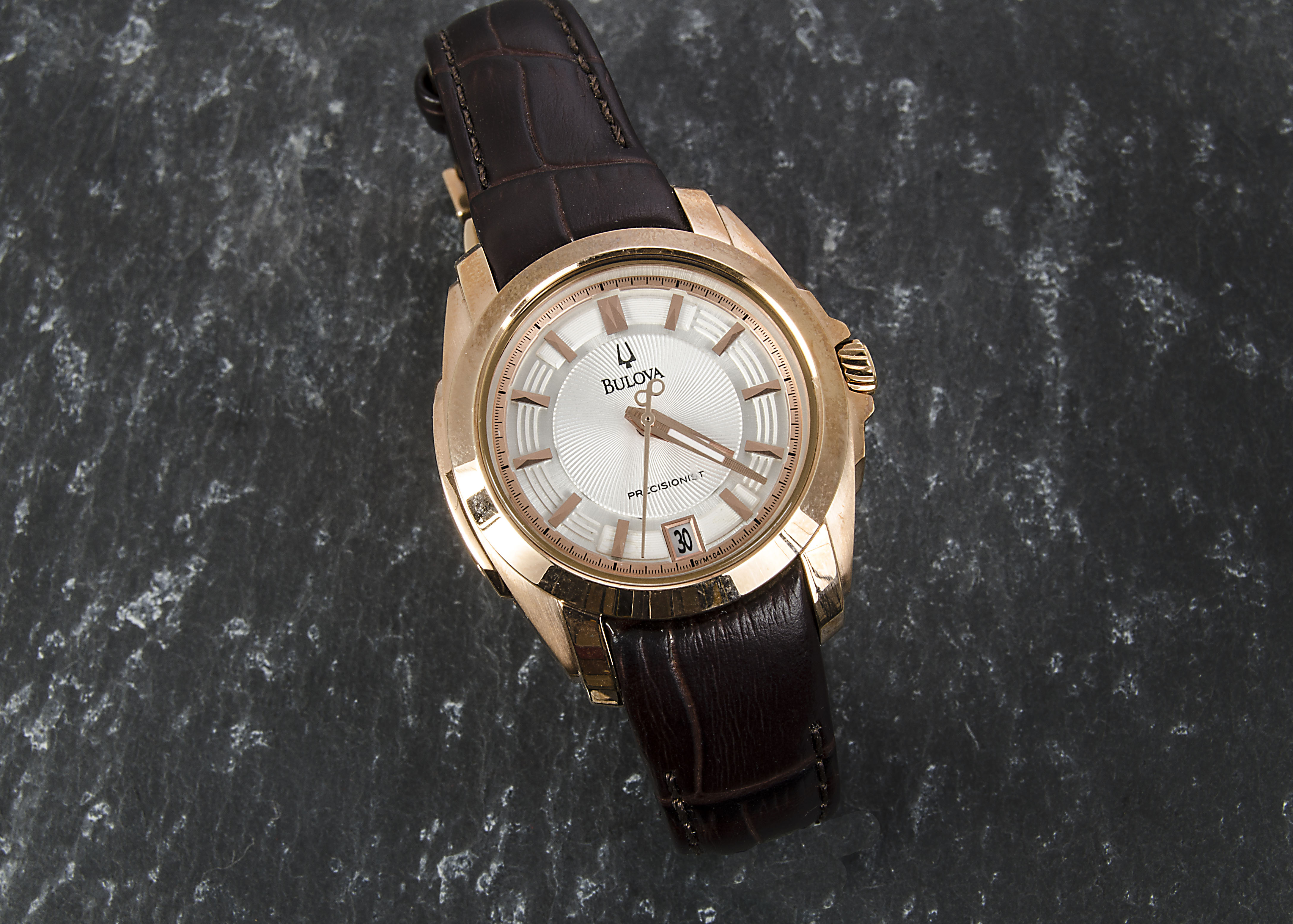 A rose gold plated Bulova Precisionist lady’s wristwatch, the silvered dial with baton numerals