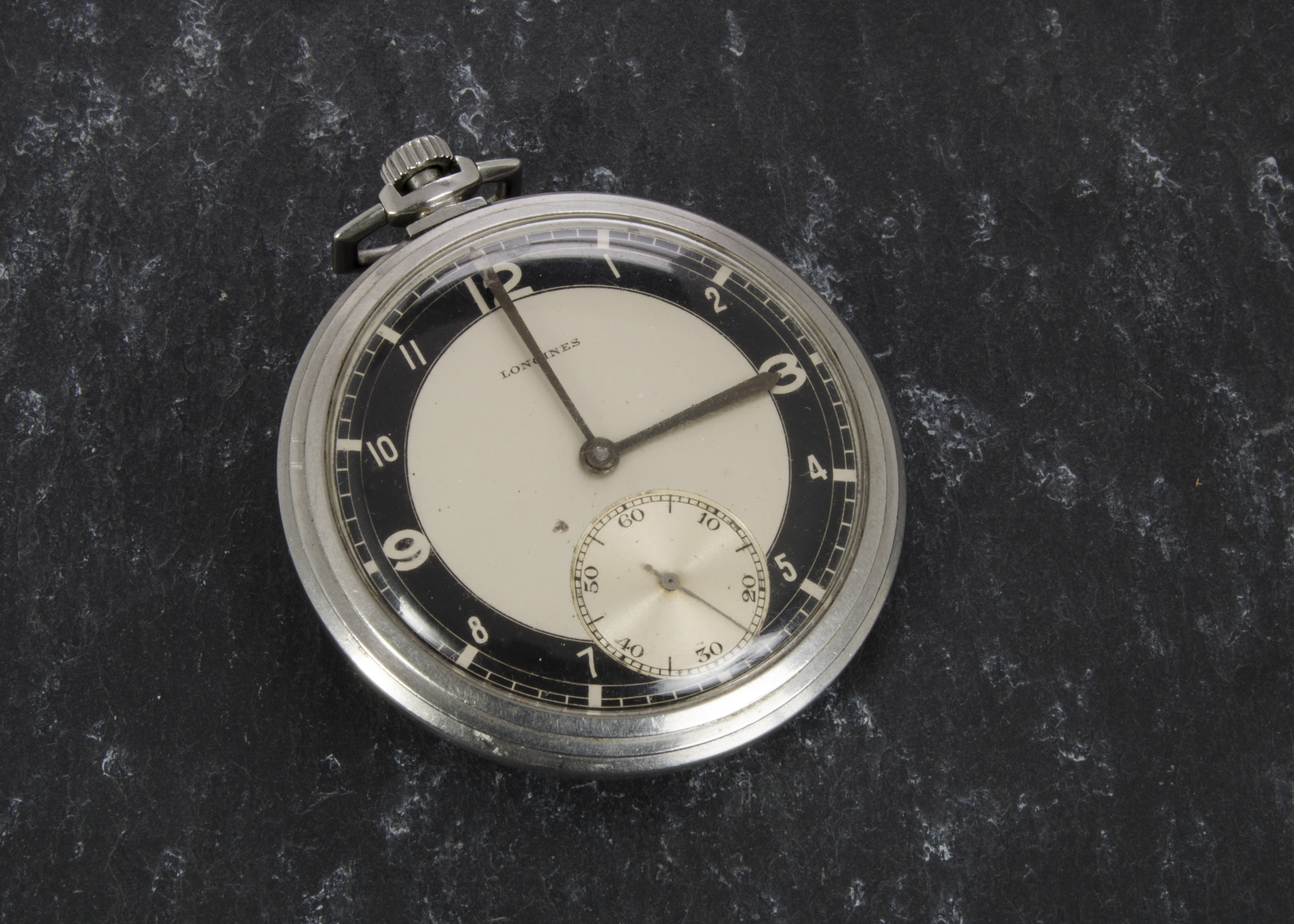 An Art Deco period open faced pocket watch by Longines, having black and silvered dial in plated
