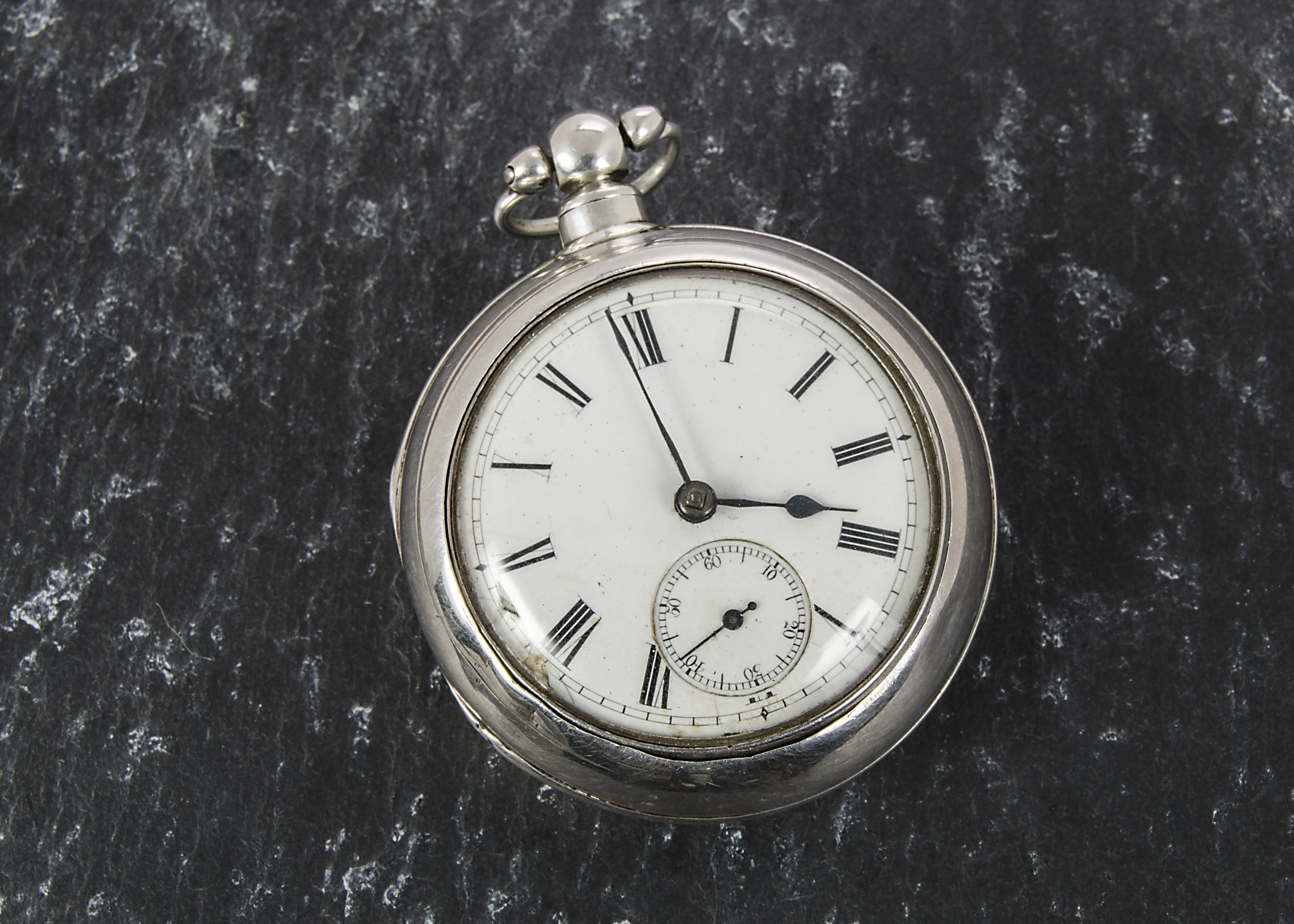 A George IV silver pair cased verge pocket watch, case marked Chester 1827, white enamel dial, black