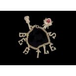 The Beatles: Original 1960s bracelet with charms of guitar a beetle and letters spelling the