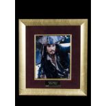 Johnny Depp Framed and glazed colour photograph of Jack Sparrow signed in black pen, with UACC