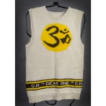 The Beatles / George Harrison: A hand knitted sleeveless jumper with 'OM' logo, this jumper was