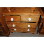 A small Victorian pine chest, two over two drawers with porcelain handles, on turned feet 85cm W