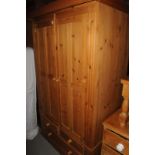 A Pinecraft double wardrobe, on a two over single drawer base 117cm W x 190cm H