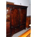 An Edwardian mahogany press cupboard, with false drawer fronts and blind fretwork 185.5cm H
