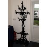 A modern reproduction Victorian cast iron hall stand, the Coalbrookdale style black painted piece