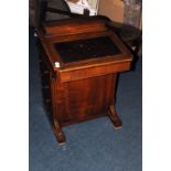 A Victorian walnut davenport desk, with boxwood stringing on a mahogany carcass