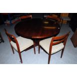 A Skovby Mobelfabrik A/S rosewood dining table, complete with two original leaves, and matching