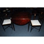 A pair of English Art Nouveau corner chairs, and a sprung drop leaf mahogany inlaid table (3)