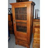 A 20th century continental hall cabinet, with turned wooden bars to the doors 181.5cm H