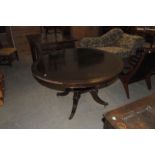 A Regency rosewood snap top breakfast table, of circular form and with brass banding to the top