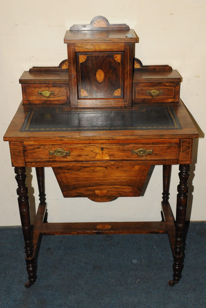 A rosewood inlaid work table, fitted with frieze and lower drop compartment, the top with raised