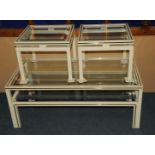 A set of three occasional tables, by Pierre Vandel Paris, with bevelled glass tops and cream
