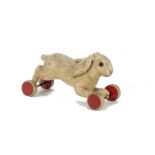 A late 1930s Steiff running rabbit on eccentric wheels, with light brown wool/mohair plush, brown