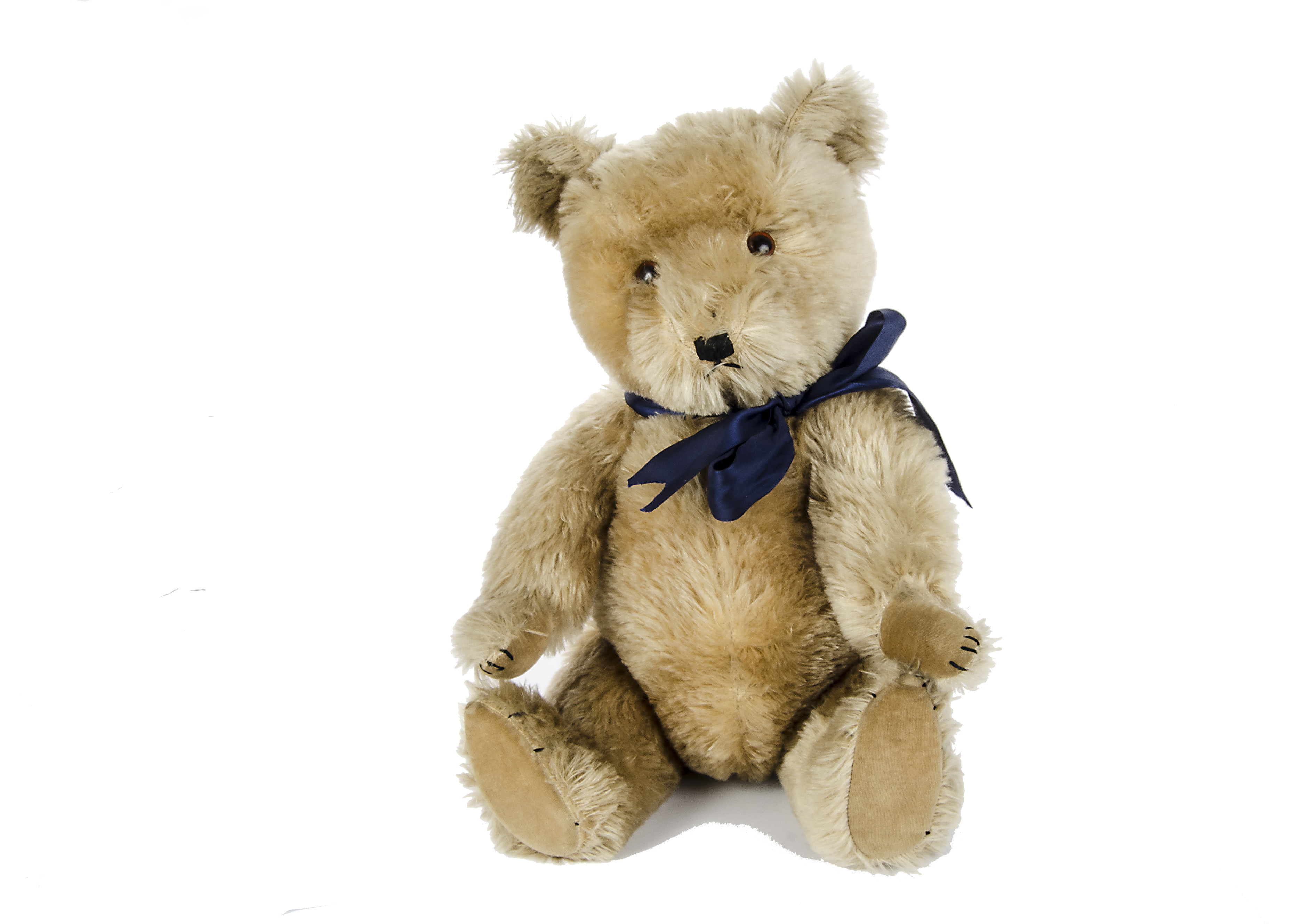 A Chiltern Hugmee Teddy Bear, 1950s, with blonde mohair, orange and black plastic eyes, black