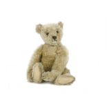 An early Steiff Teddy Bear, circa 1910, with blonde mohair, black boot eyes, pronounced clipped