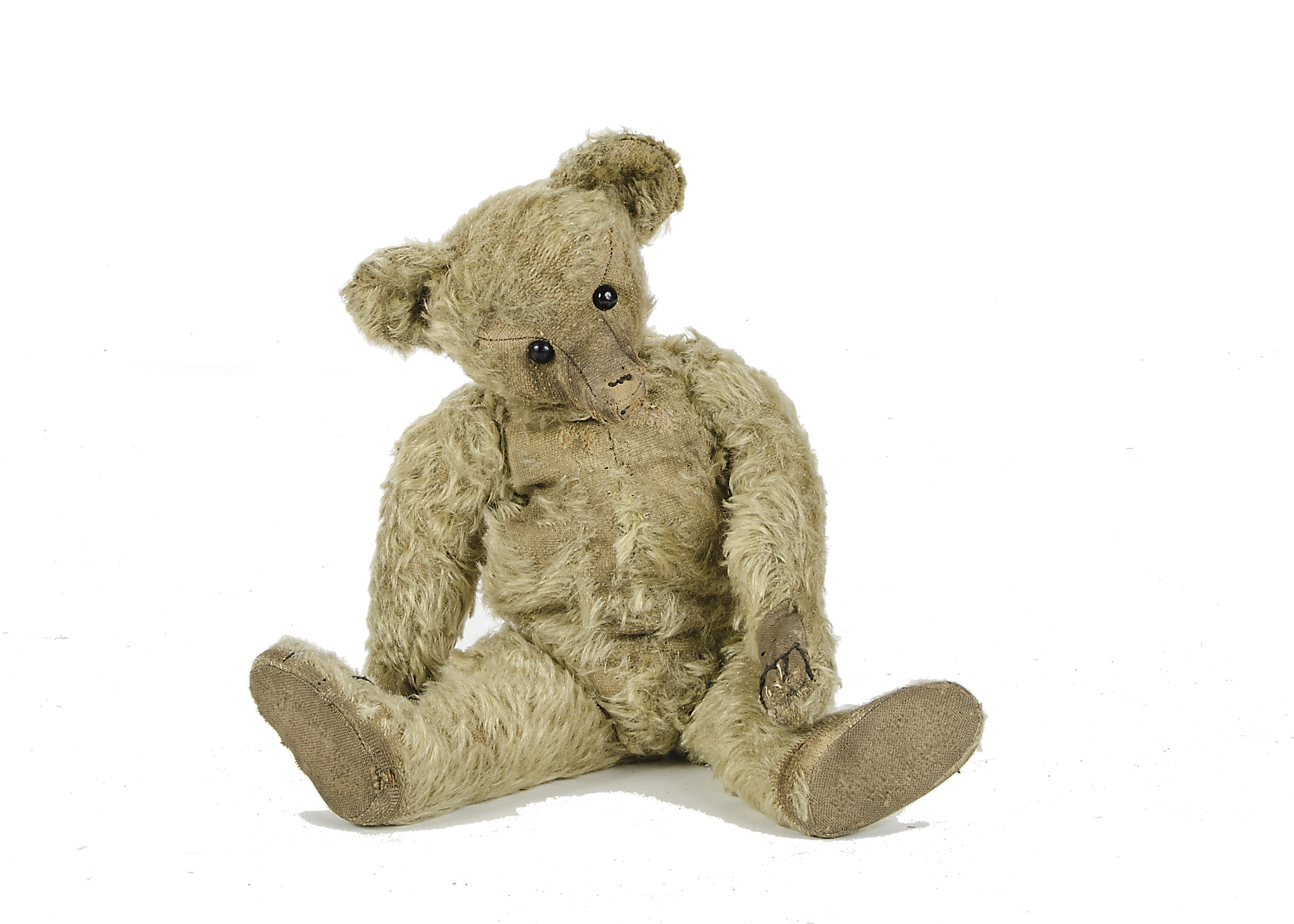 An early Farnell Teddy Bear, 1910-20s, with blonde mohair, boot button eyes, pronounced thin long