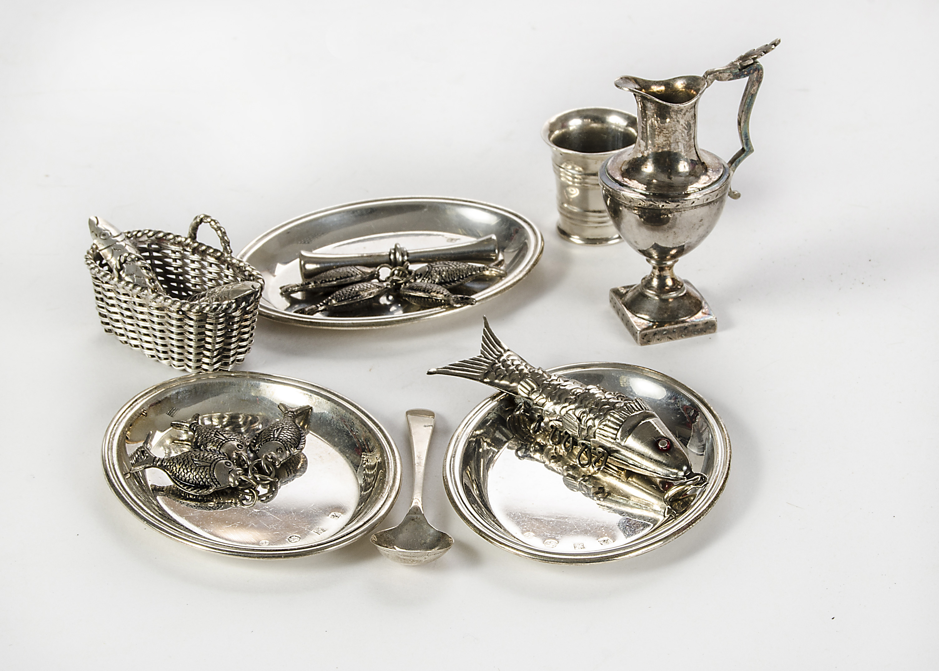 Continental silver dolls’ house chattels: three oval platters - 2½in. (6cm.) wide; a ewer; a