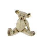 An unusual British Teddy Bear, 1920s, with blonde mohair, oily clear and black glass eyes with