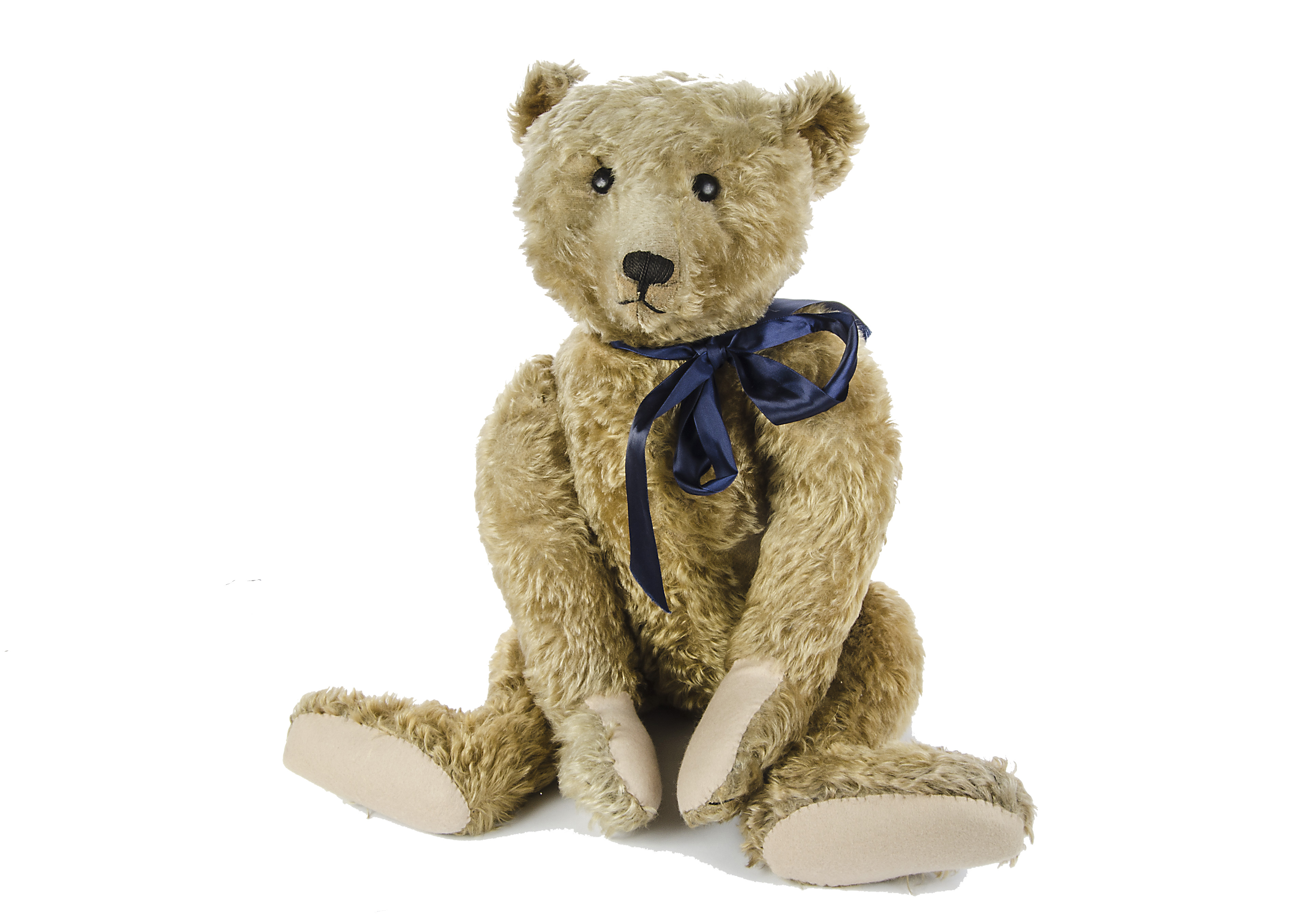 A large early Steiff Teddy Bear, circa 1910, with dark blonde mohair, black boot button eyes,