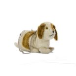 A rare British lying dog purse, 1930s, with white and brown mohair, orange and black glass eyes,