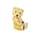 A Chiltern Hugmee Teddy Bear, circa 1958, with bright golden mohair, orange and black plastic