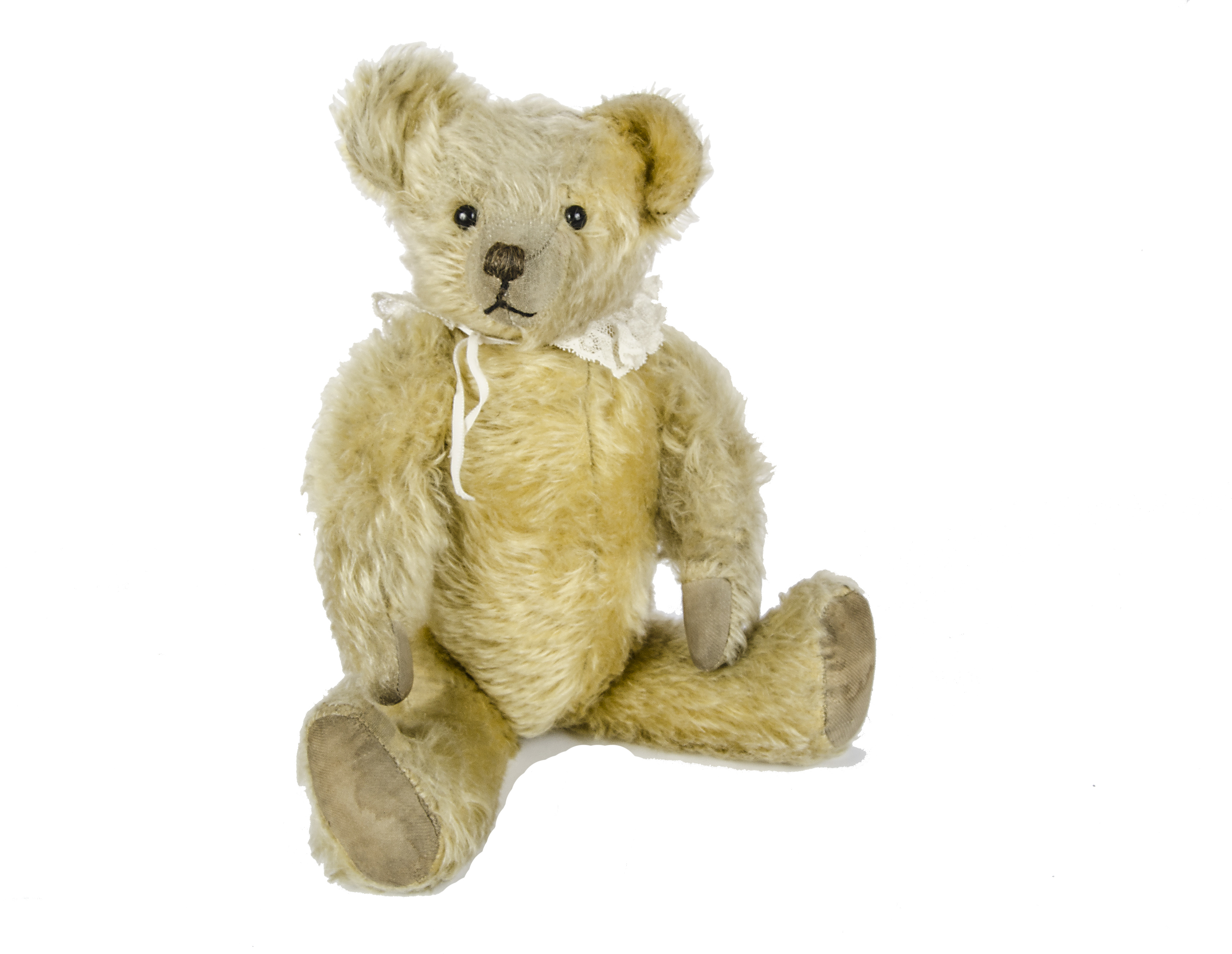 A early British Teddy Bear, 1920s, with pale golden mohair, black boot eyes, pronounced clipped
