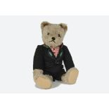 A rare Schuco dressed yes/no Teddy Bear, 1950s, with beige mohair, clear and black glass eyes with