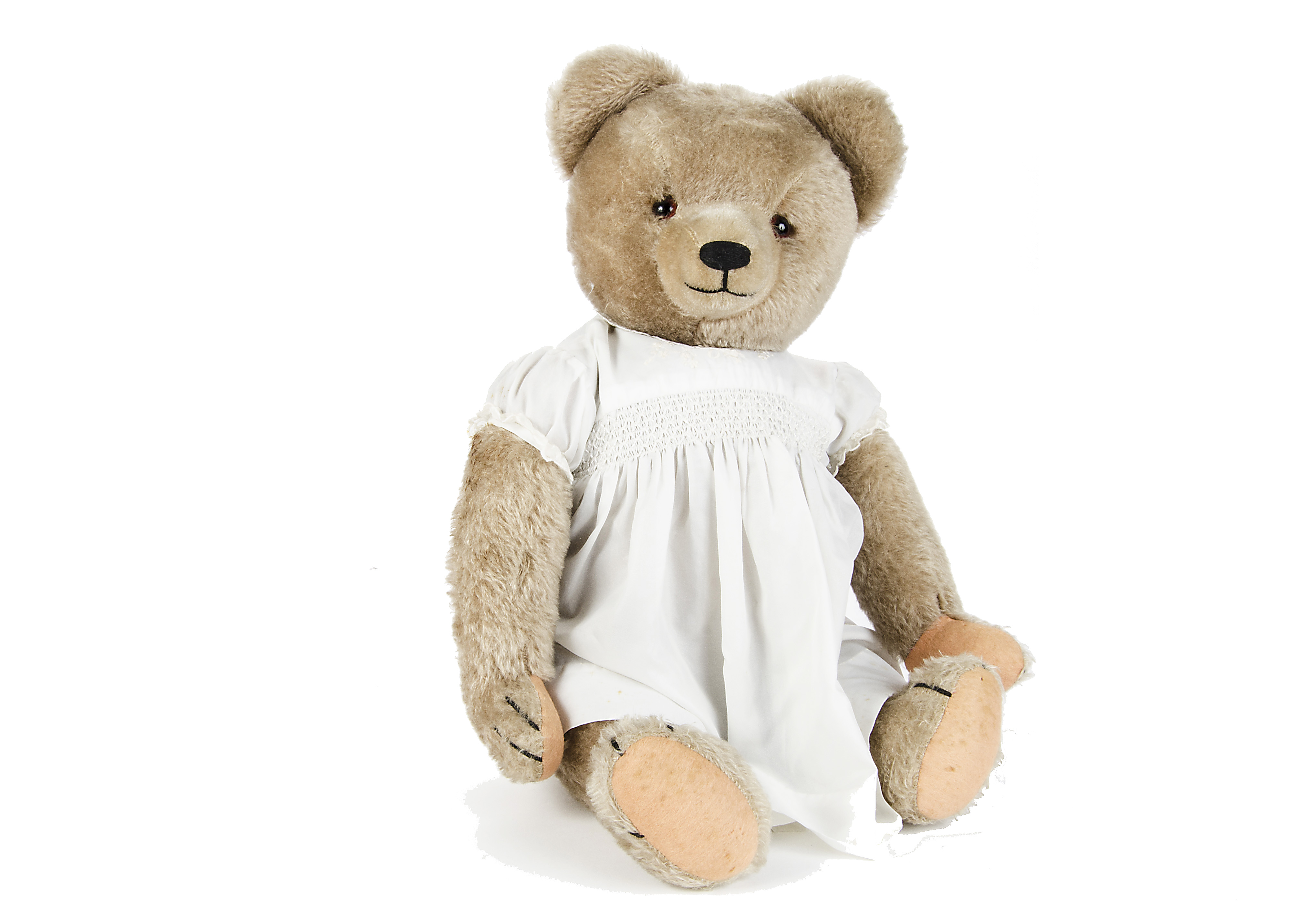 A Hermann Teddy Bear, 1950s, with beige mohair, orange and black glass eyes, pronounced short mohair