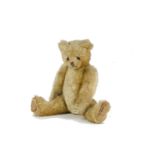A fine and early British Teddy Bear, 1910-1920s, with pale golden mohair, boot button eyes,
