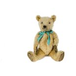 A 1930s Chiltern Teddy Bear, with golden mohair, replaced glass eyes, pronounced muzzle, black