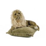 A rare and early Steiff lying velvet lion, with black boot button eyes, black shading behind eyes,