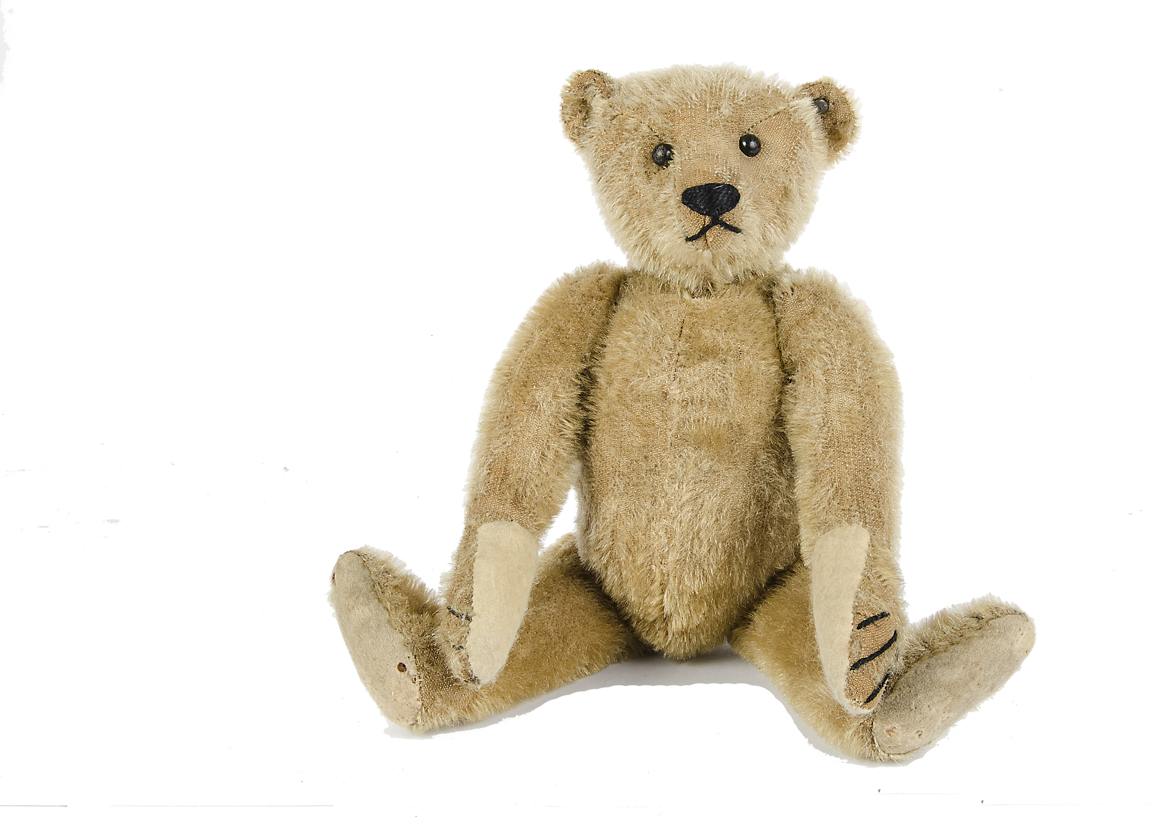 An early Steiff Teddy Bear, circa 1910, with dark blonde mohair, black boot button eyes,