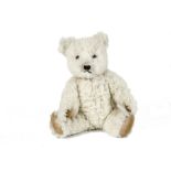 A Chiltern Hugmee Teddy Bear, 1950s, with white synthetic wool plush, orange and black glass eyes,
