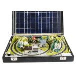 A Z Gauge solar-powered layout in a black briefcase 14”x19”x4”: a continental summer scene with