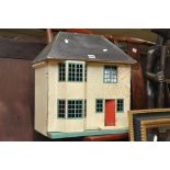 A vintage 1950's dolls house with some f