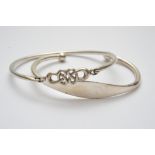 A silver bangle of Celtic design and one