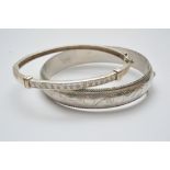 Two silver bangles, one inset with simul